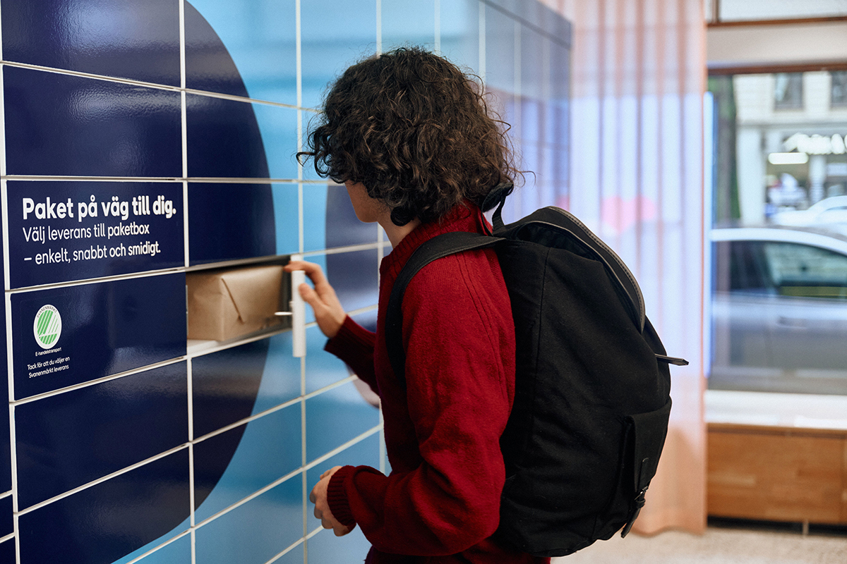 Teenager picking up parcel at parcel locker